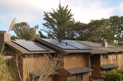 Brown brick house with solar panels on the roof